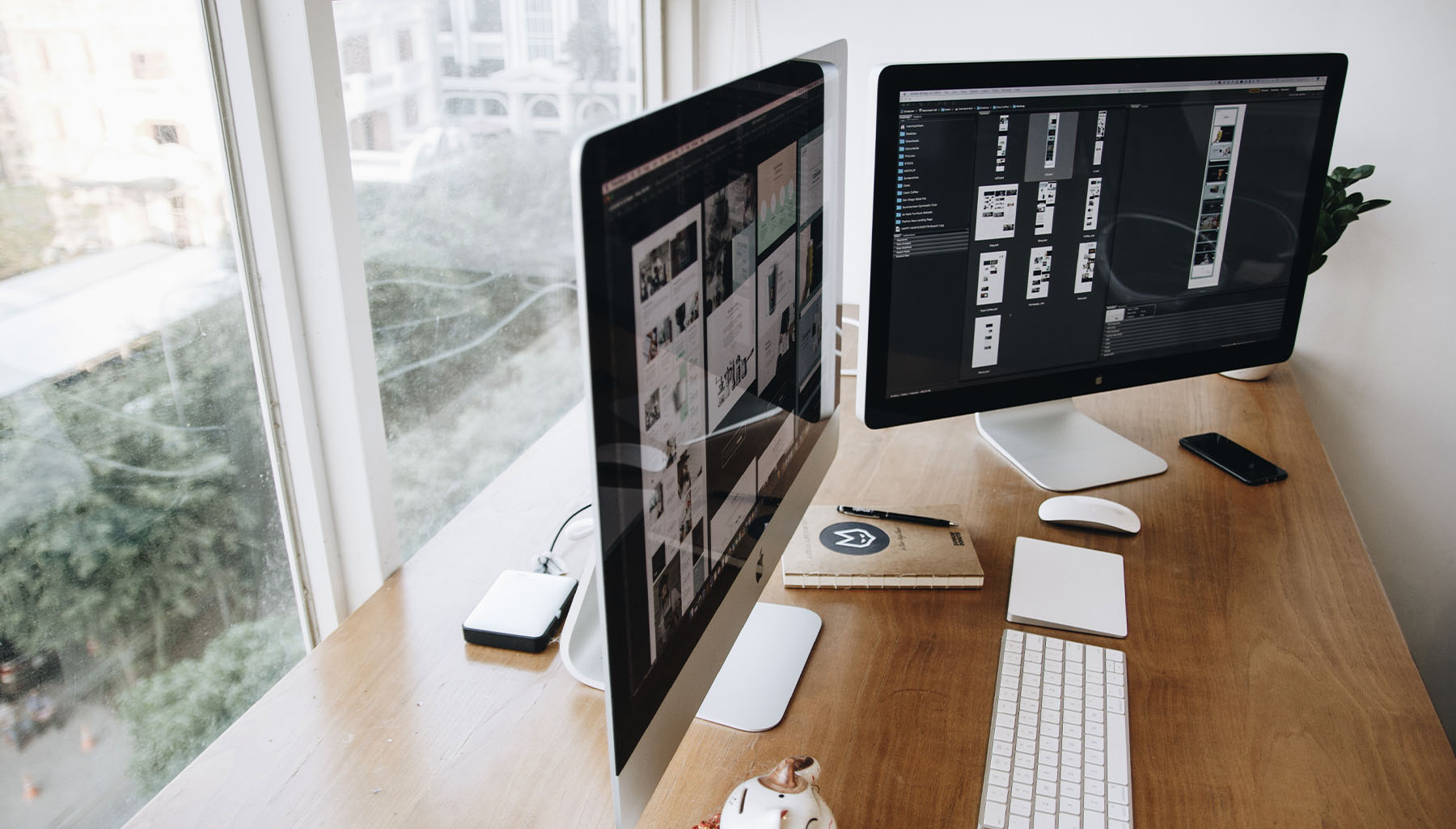 A designers desk, facing the window away from the office